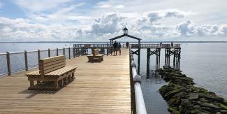 Fishing pier with white clouds in the distance